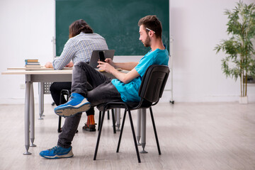 Obraz premium Two male pupils in bullying concept in the classroom