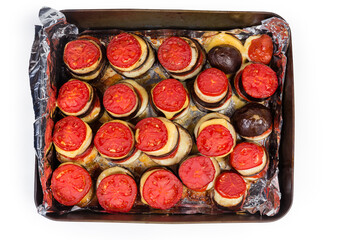 Eggplants slices baked with tomatoes and cheese on oven tray