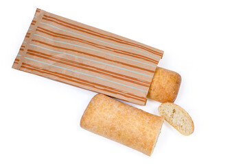 Partly cut ciabatta, whole ciabatta half bagged in paper bag