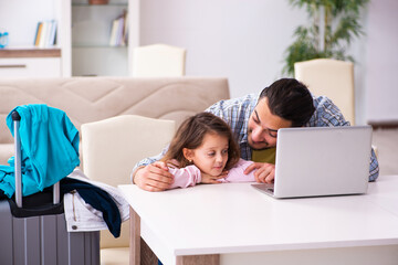 Young man and his small daughter preparing for the trip