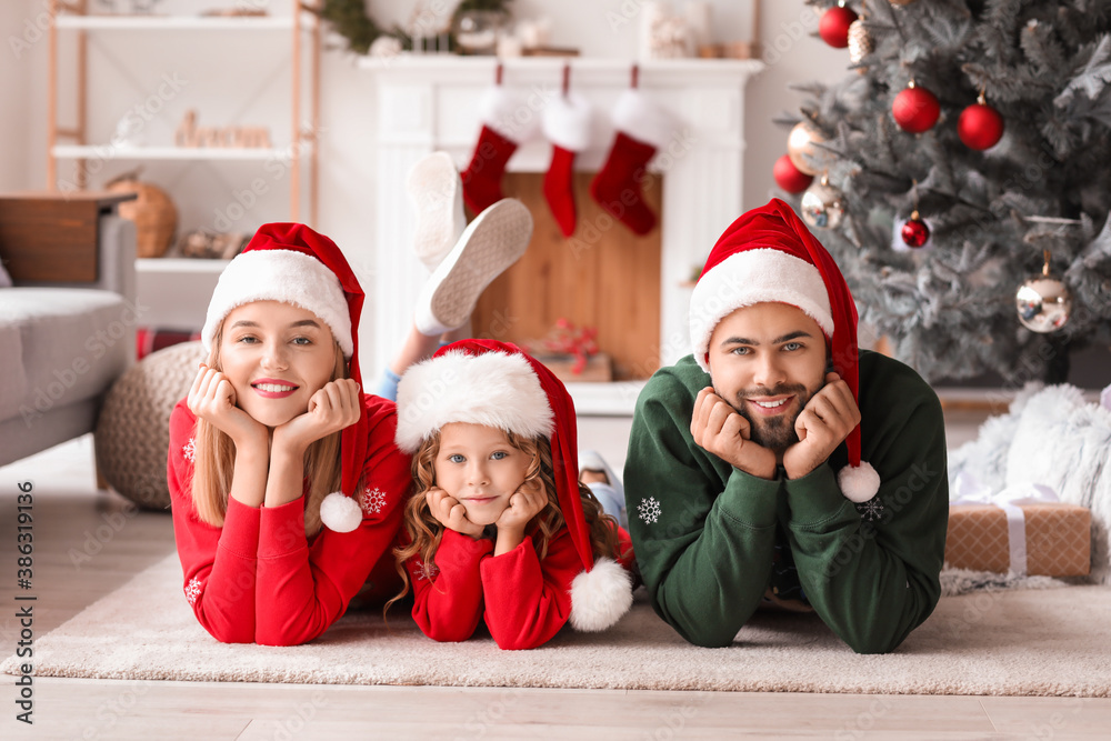 Wall mural Young family at home on Christmas eve