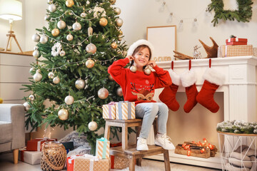 Obraz na płótnie Canvas Cute little girl at home on Christmas eve