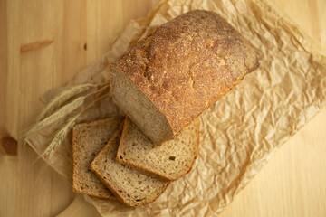 bread and sliced bread on wooden table