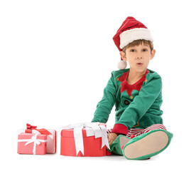 Surprised little elf with Christmas gifts on white background