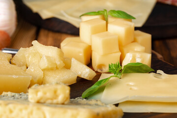 Cut pieces of hard cheese close up