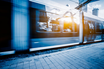 Modern tram in downtown at sunset. - obrazy, fototapety, plakaty