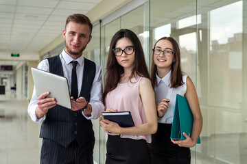 Fototapeta premium Serious two businesswoman and men show document and talk about mistake to subordinate in office