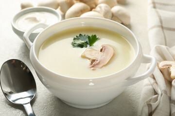 Bowl of tasty mushroom soup with champignons, close up