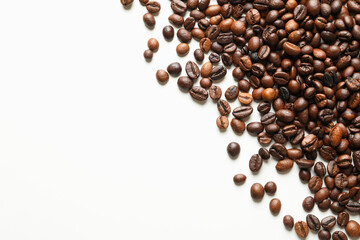 Roasted coffee beans on white background, space for text