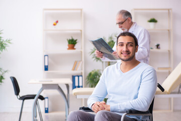Young man in wheel-chair and old doctor radiologist