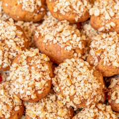 melomacarona, traditional Greek Christmas gourmet cookies with honey syrup and nuts, brown pattern background