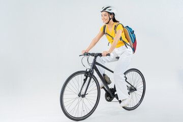 Asian beautiful woman, she is riding a city bike to work.