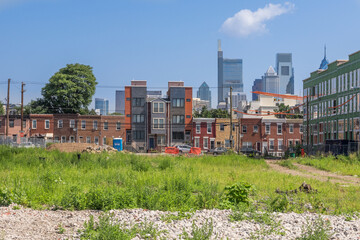 Fototapeta na wymiar A work in progress - Gentrification in a south Philadelphia neighborhood with downtown skyline.
