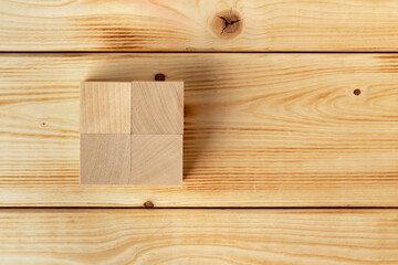 Groupped wooden square blocks on dark wooden table