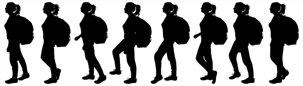A girl with a backpack on her back. Women are stepping in line. Tourists are on the move. Side view, profile. Hiking. The black female silhouettes are isolated on a white background.