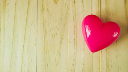  pink heart on wood table for Health and medical content..