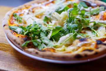 Pizza close-up. Traditional Italian pizza on a table, selective focus, blurred background.