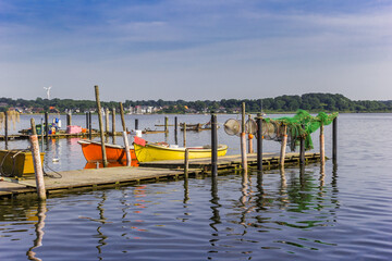 Fototapeta na wymiar Colorful fishing boats at the jetty in Holm village of Schleswig, Germany