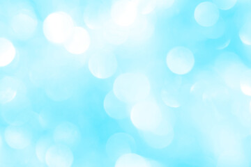 Obraz premium Bokeh light on blue background, sky with circle glitter light blue. Snow abstract soft glowing with vivid bright light and bokeh blur effect. 