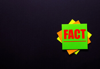 The word FACT on a bright sticker on a dark background