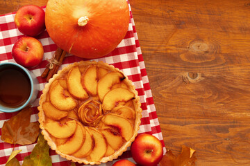 Homemade traditional sweet autumn tart pie on wooden table
