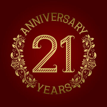 Golden emblem of twenty first anniversary. Celebration patterned sign on red.