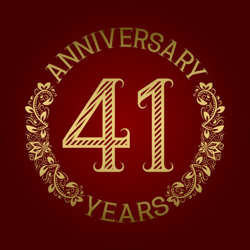 Golden emblem of forty first anniversary. Celebration patterned sign on red.