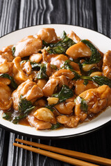 Sanbeiji is a popular chicken dish in Chinese cuisine closeup on the plate. Vertical