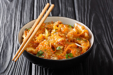 Delicious Guo Bao Rou fried pork in sweet and sour sauce close-up in a bowl. horizontal
