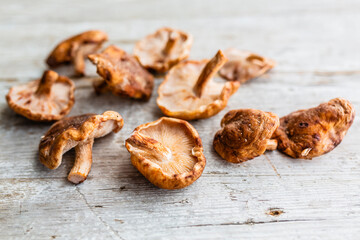 Fresh Shitake mushrooms on a wooden background.