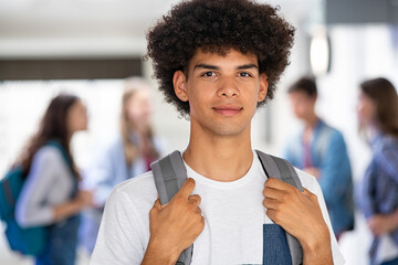 African guy standing with backpack in high school