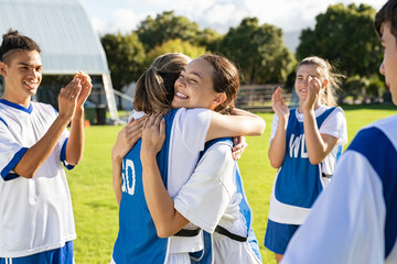 Girls soccer players celebrating victory