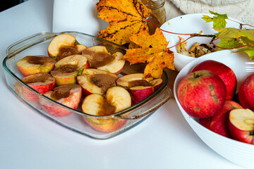 fried apples with cinnamon and honey decorated with colorful autumn leaves
