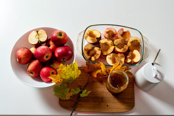 fried apples with cinnamon and honey decorated with colorful autumn leaves