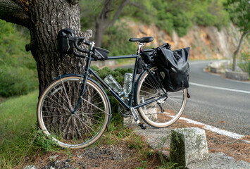 Fototapeta na wymiar Touring bicycle standing near the road with back panniers