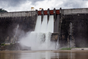 Water flowing over floodgates of a dam at Khun Dan Prakan Chon, Nakhon Nayok Province, Thailand