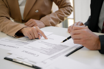 lawyer consulting with client discussing about contract.