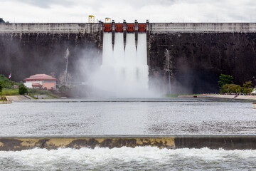 Water flowing over floodgates of a dam at Khun Dan Prakan Chon, Nakhon Nayok Province, Thailand