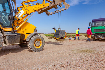 Vibration plate machine hang on excavator's front bucket