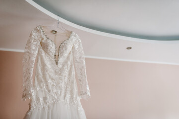 Fashionable beautiful classic lace brides dress in room. morning preparation wedding concept. vintage gown.