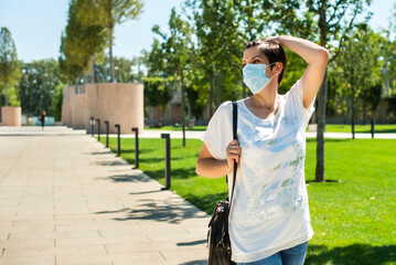 health, safety and pandemic concept - sad senior woman wearing protective medical mask for protection from virus walks