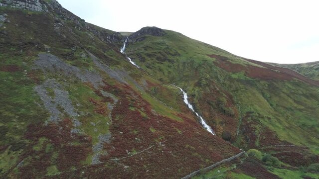 Idyllic Snowdonia mountain range Aber falls waterfalls national park aerial view valley pull back pan left