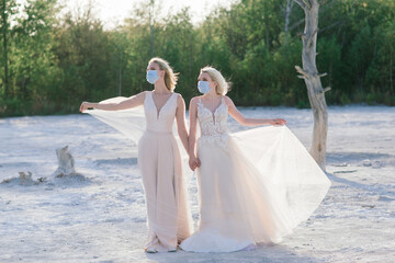 Fototapeta na wymiar Lesbian couple wedding, wear masks to prevent epidemic COVID-19