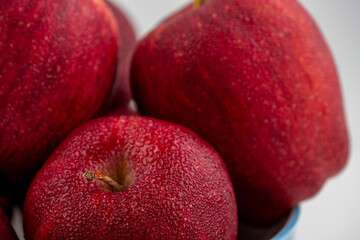 Close up of pile of red apple with clear water drop on 
shell surface texture pattern isolated, white background