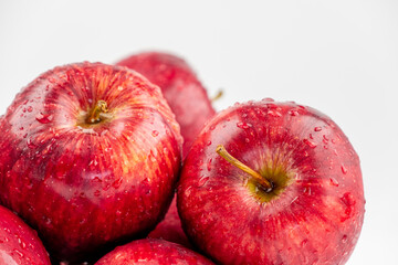 Pile of red apple with clear water drop on shell surface texture pattern isolated, white background