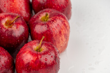 Pile of red apple with clear water drop on shell surface texture pattern isolated, white background