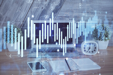 Double exposure of chart and financial info and work space with computer background. Concept of international online trading.