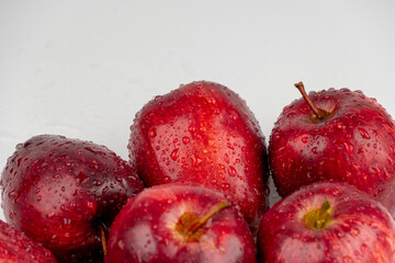 Pile of red apple with clear water drop on shell surface texture pattern isolated, white background