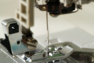 Sewing machine with focus on needle, shallow depth of field