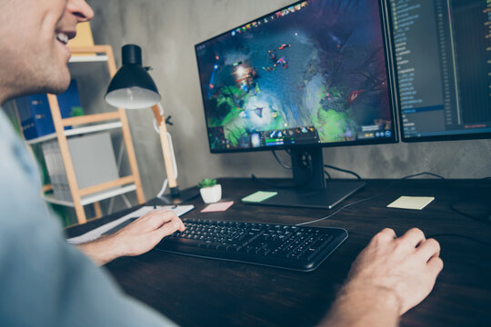 Cropped close up view photo of pc monitor guy play video game sit desk in modern house indoors inside room